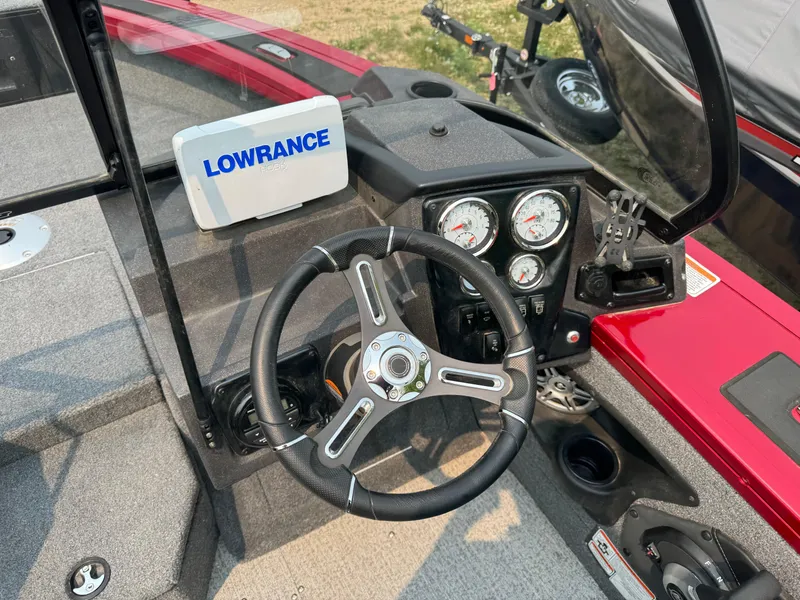 Slide: The Image of 2023 Tracker Targa V-18 WT boat dashboard with steering wheel and Lowrance display. - 8