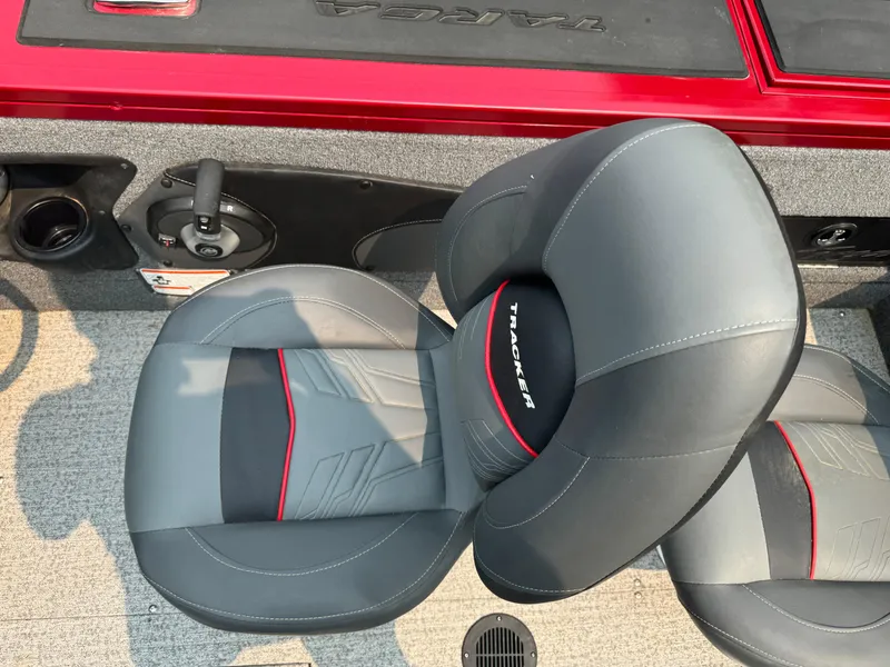 Slide: The Image of 2023 Tracker Targa V-18 WT boat seat with gray upholstery and red accents. - 9