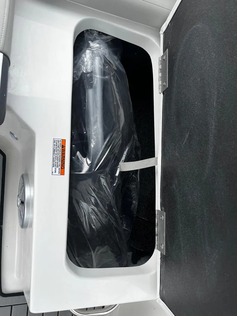 Slide: The Image of 2024 Starcraft SVX 190 storage compartment with black interior and hinged lid. - 7