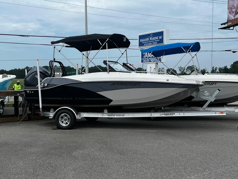 The Image of 2024 Starcraft SVX 190 boat on a trailer at a dealership. - 1