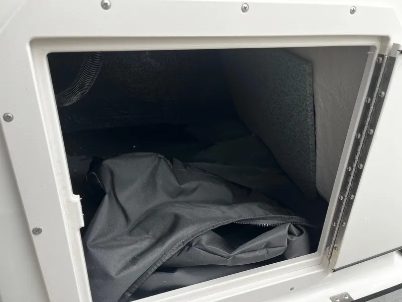 Slide: The Image of Storage compartment of 2024 Starcraft SVX 190 boat with black bag inside. - 12