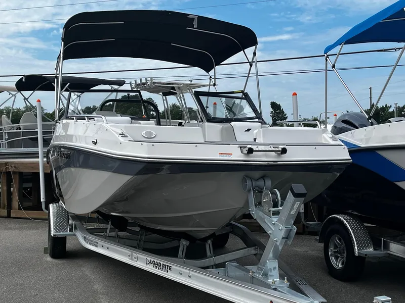 Slide: The Image of 2024 Starcraft SVX 190 boat on a trailer with a black canopy. - 2