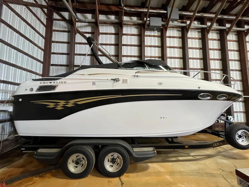 Slide: The Image of 2000 Crownline 242 CR boat on trailer in storage facility. - 1