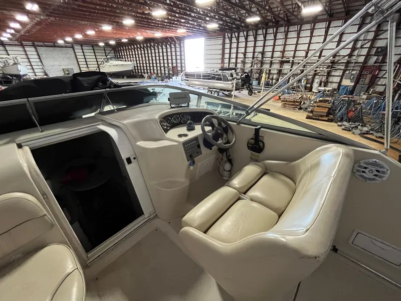 Slide: The Image of 2000 Crownline 242 CR boat interior in a spacious storage facility. - 10