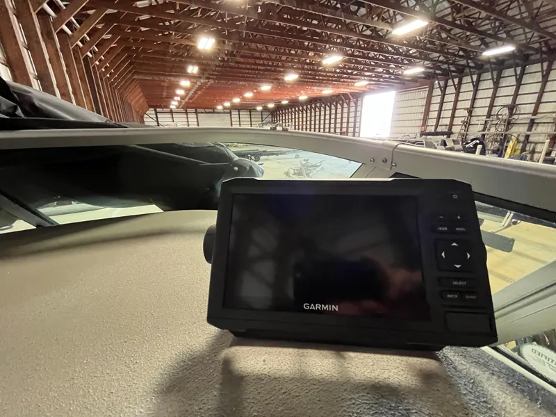Slide: The Image of Garmin device on 2000 Crownline 242 CR boat dashboard in a large warehouse. - 12