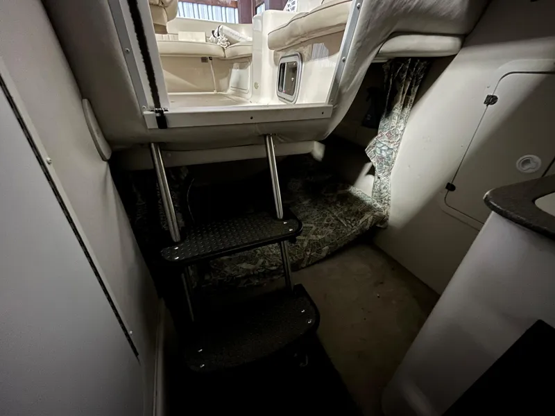 Slide: The Image of Interior cabin of 2000 Crownline 242 CR boat with steps and seating area. - 18