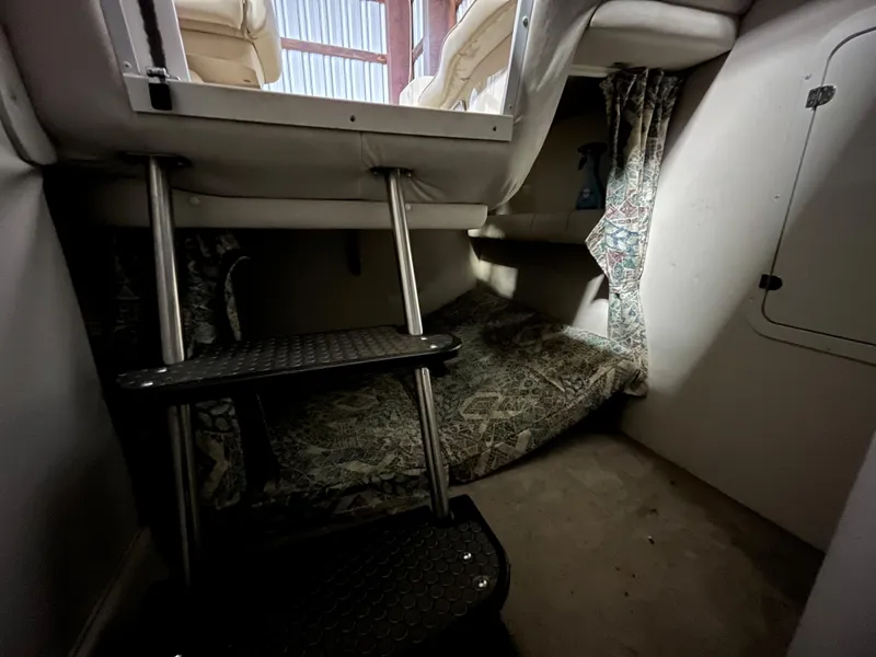 Slide: The Image of Interior cabin of 2000 Crownline 242 CR boat with steps and patterned curtains. - 19
