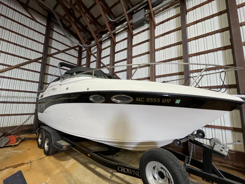 Slide: The Image of 2000 Crownline 242 CR boat on trailer in storage facility. - 2