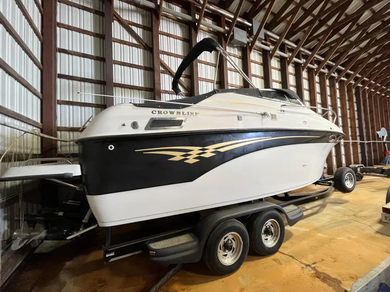 Slide: The Image of 2000 Crownline 242 CR boat on trailer in storage facility. - 3