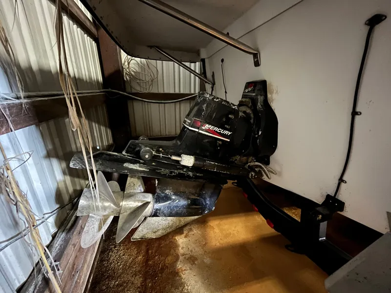 Slide: The Image of Crownline 242 CR 2000 boat engine in storage, featuring a Mercury outboard motor. - 4