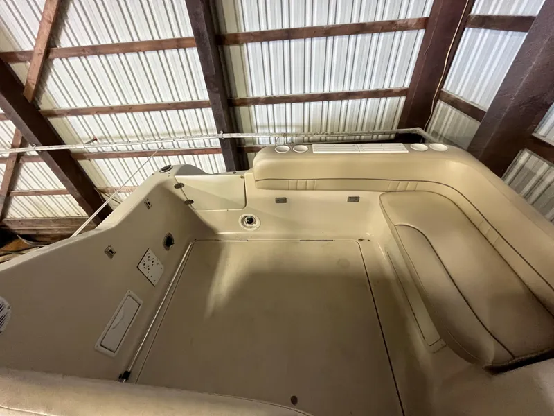 Slide: The Image of Interior view of a 2000 Crownline 242 CR boat, showcasing seating and storage. - 6