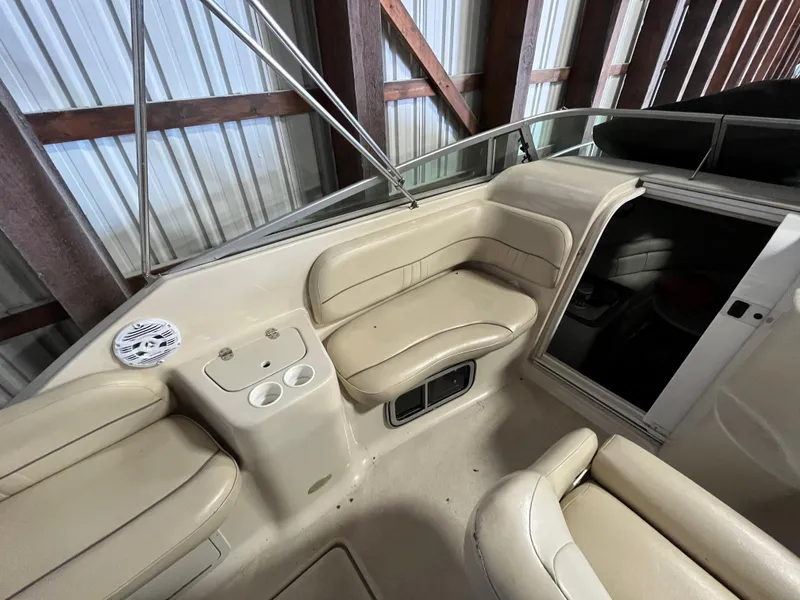 Slide: The Image of Interior of 2000 Crownline 242 CR boat with beige seating and cup holders. - 9
