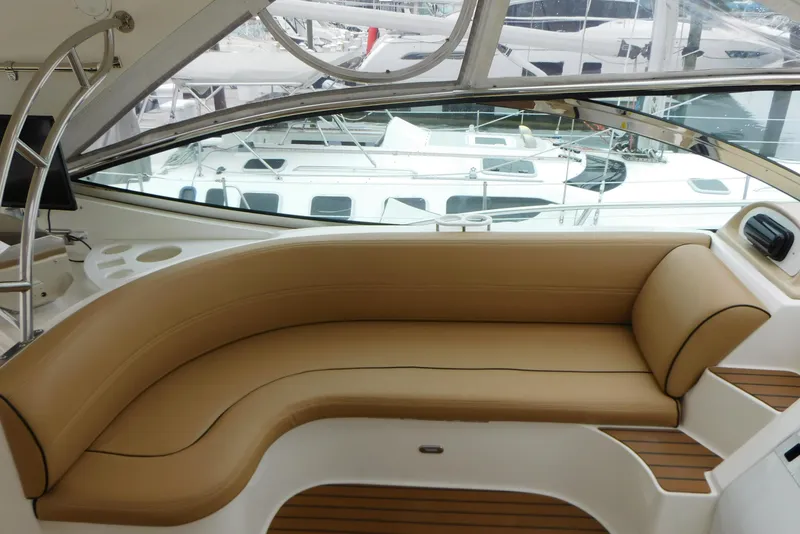 Slide: The Image of 2005 Cruisers Yachts 520 Express interior with tan seating and sleek design. - 11