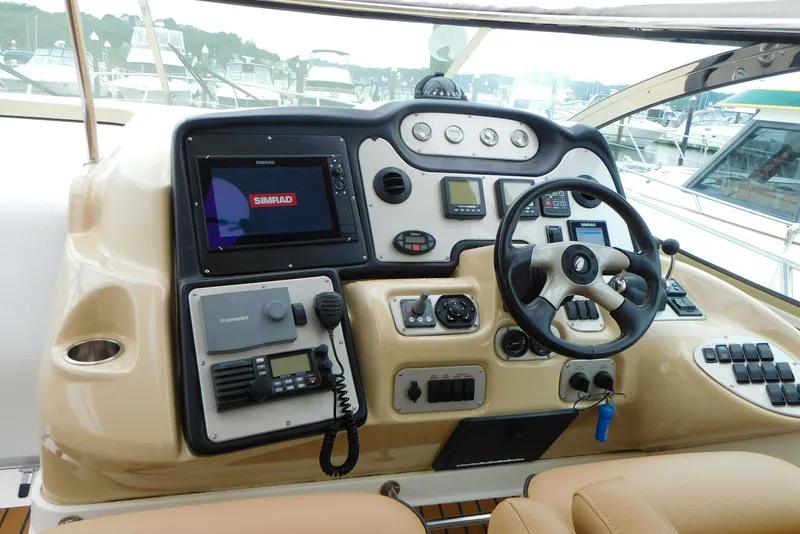 Slide: The Image of 2005 Cruisers Yachts 520 Express helm with navigation equipment and steering wheel. - 13