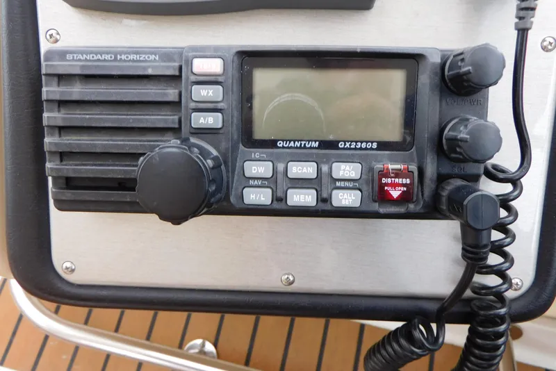 Slide: The Image of VHF radio on 2005 Cruisers Yachts 520 Express, featuring distress button and control knobs. - 16