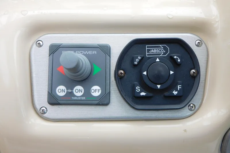 Slide: The Image of Control panel of a 2005 Cruisers Yachts 520 Express, featuring joystick and dial controls. - 17