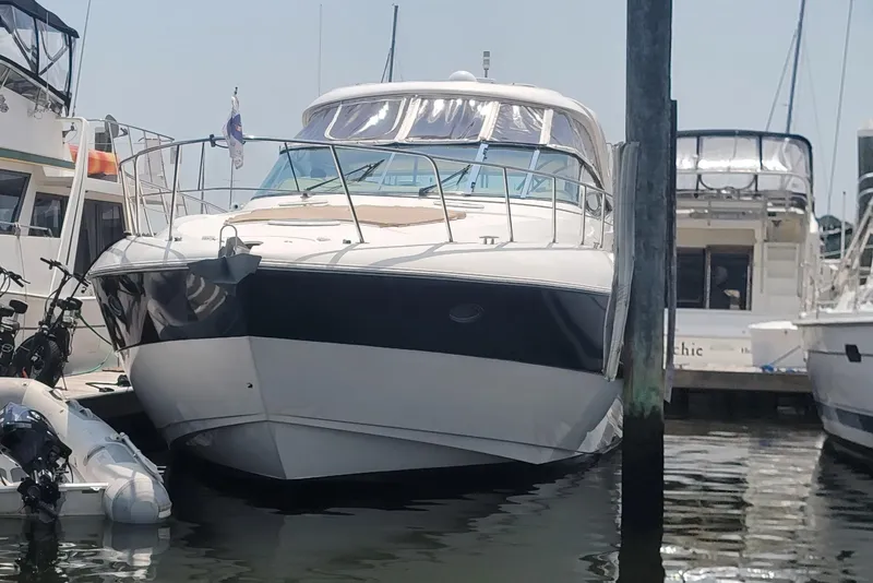 Slide: The Image of 2005 Cruisers Yachts 520 Express docked at marina, front view. - 2