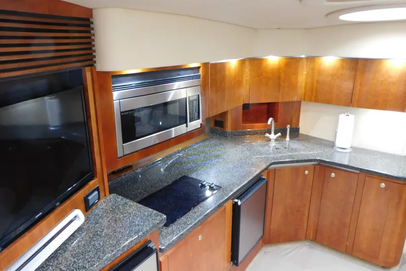 Slide: The Image of 2005 Cruisers Yachts 520 Express kitchen with modern appliances and sleek countertops. - 21