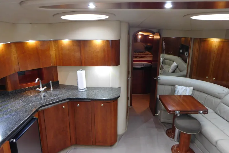 Slide: The Image of Luxurious 2005 Cruisers Yachts 520 Express interior with modern kitchen and cozy seating area. - 22