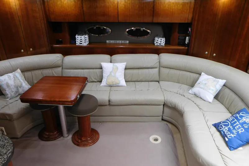 Slide: The Image of Luxurious 2005 Cruisers Yachts 520 Express interior with plush seating and elegant wooden accents. - 24