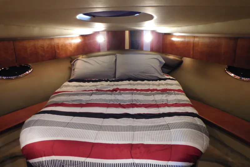 Slide: The Image of Luxurious 2005 Cruisers Yachts 520 Express cabin with cozy bed and ambient lighting. - 27