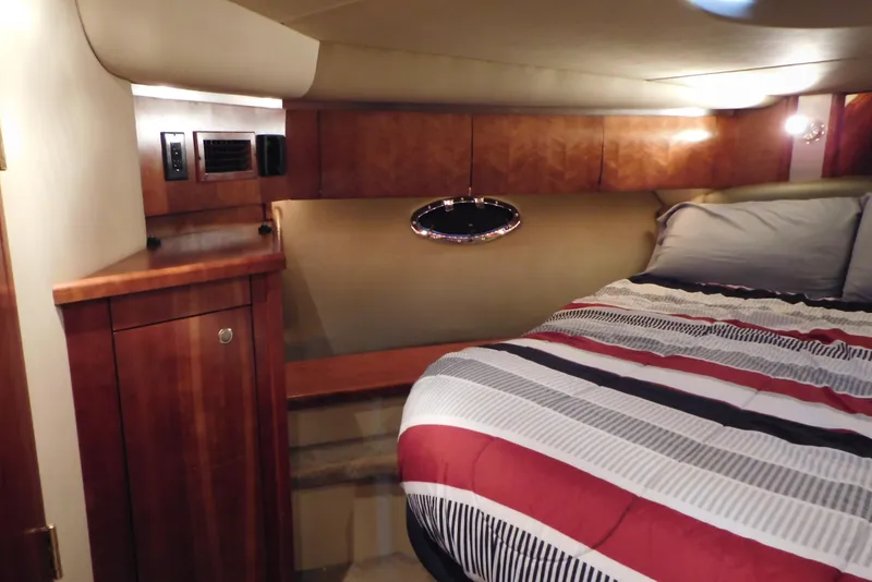 Slide: The Image of Luxurious cabin interior of 2005 Cruisers Yachts 520 Express with cozy bedding. - 28
