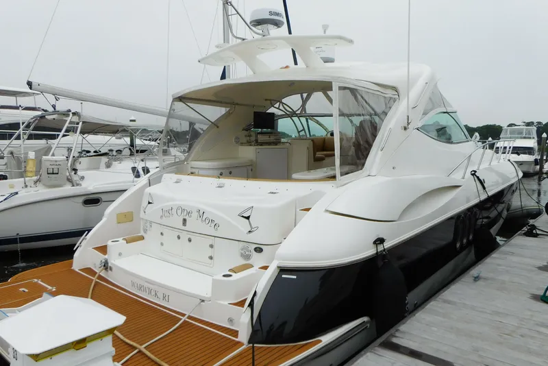 Slide: The Image of 2005 Cruisers Yachts 520 Express docked, showcasing sleek design and spacious deck. - 3
