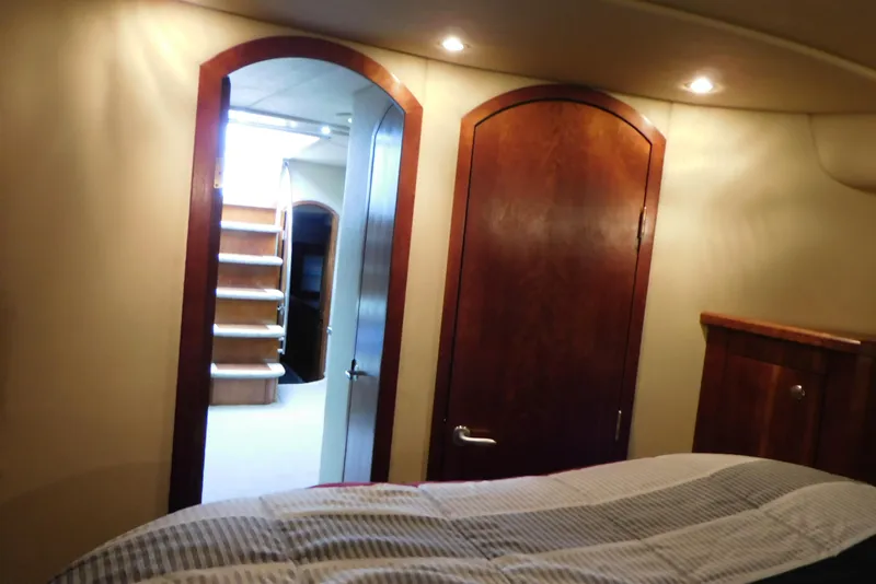 Slide: The Image of Interior of 2005 Cruisers Yachts 520 Express with wooden doors and cozy lighting. - 30