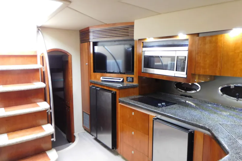 Slide: The Image of 2005 Cruisers Yachts 520 Express interior with modern kitchen and entertainment area. - 35