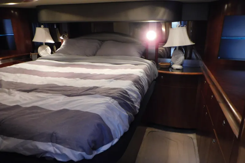 Slide: The Image of Luxurious bedroom interior of 2005 Cruisers Yachts 520 Express with elegant bedding and lamps. - 37