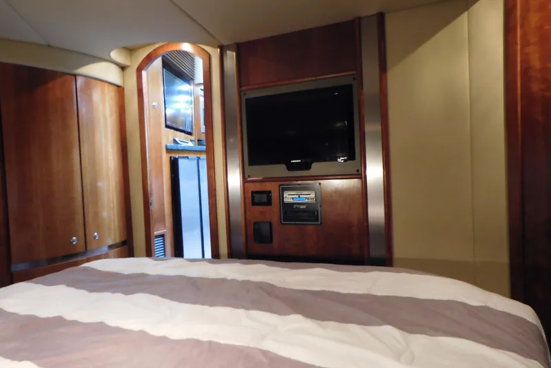 Slide: The Image of Luxurious cabin interior of 2005 Cruisers Yachts 520 Express with TV and wood paneling. - 40