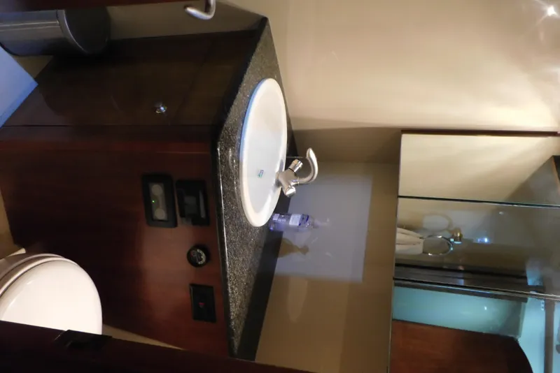 Slide: The Image of Bathroom interior of 2005 Cruisers Yachts 520 Express with sink and mirror. - 41