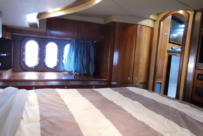Slide: The Image of Interior of 2005 Cruisers Yachts 520 Express with wood paneling and porthole windows. - 43