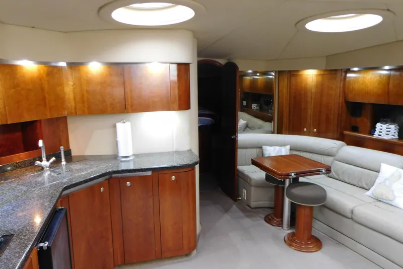 Slide: The Image of Luxurious interior of 2005 Cruisers Yachts 520 Express with wood cabinetry and plush seating. - 44
