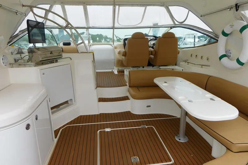 Slide: The Image of 2005 Cruisers Yachts 520 Express interior with seating, table, and helm. - 7