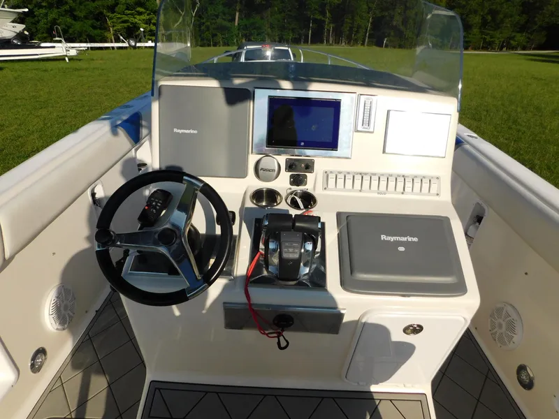 Slide: The Image of Control panel of a 2005 Solid Craft LIMITED 40 boat with steering wheel and navigation equipment. - 11