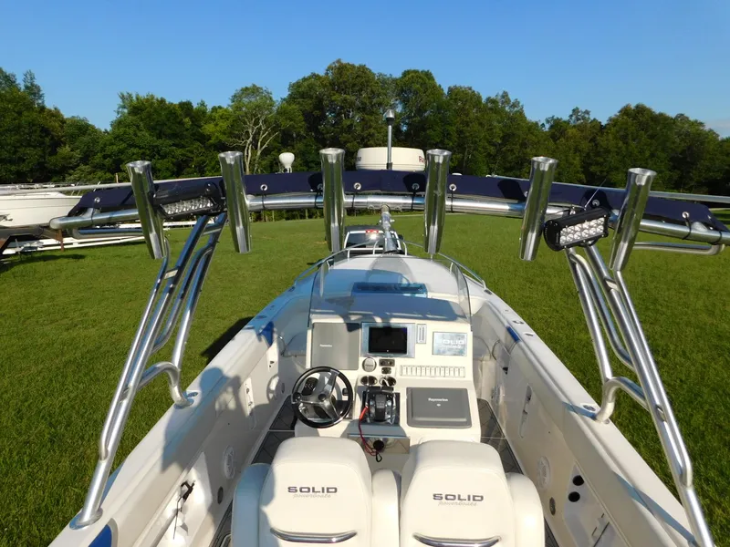 Slide: The Image of 2005 Solid Craft LIMITED 40 boat with sleek design and advanced controls, set on grassy landscape. - 14