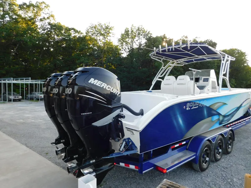 Slide: The Image of 2005 Solid Craft LIMITED 40 boat with triple Mercury outboard engines on a trailer. - 2