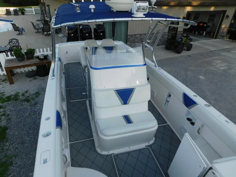 Slide: The Image of 2005 Solid Craft LIMITED 40 boat with blue and white seating, spacious deck, and canopy. - 21