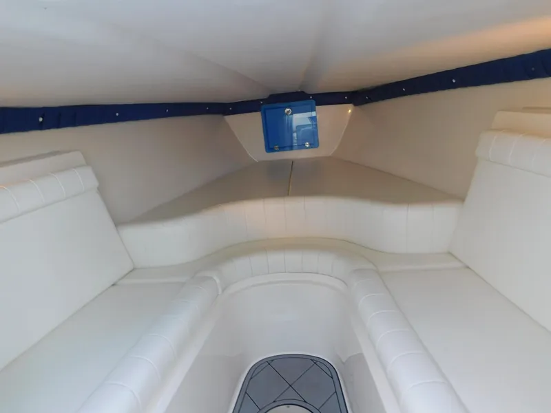 Slide: The Image of Interior cabin of 2005 Solid Craft LIMITED 40 boat, featuring white seating and blue accents. - 32