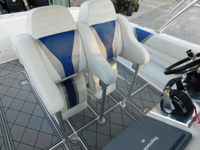 Slide: The Image of Two white and blue seats on a 2005 Solid Craft LIMITED 40 boat. - 35