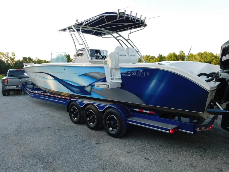 Slide: The Image of 2005 Solid Craft LIMITED 40 boat on trailer, featuring sleek blue design and triple-axle support. - 40