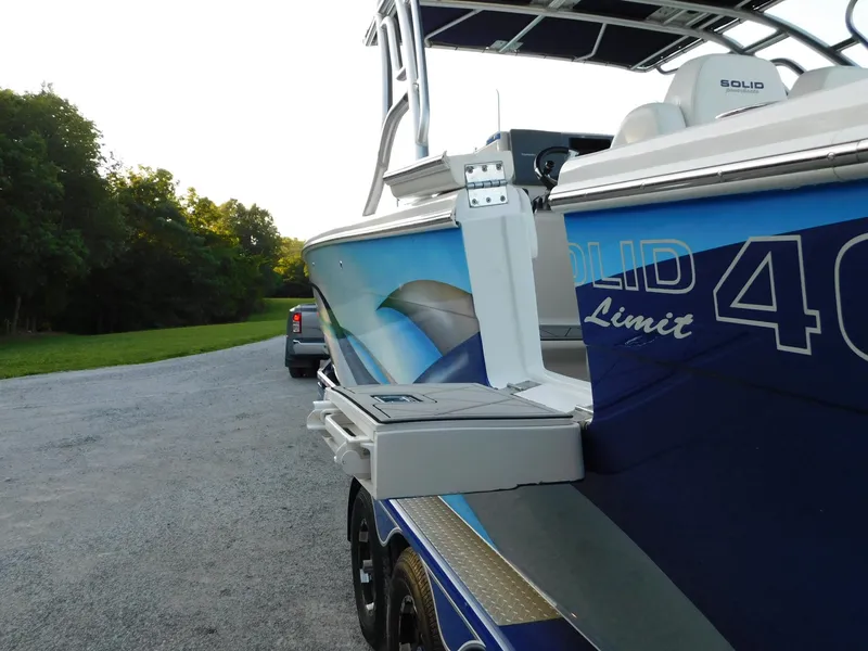 Slide: The Image of Solid Craft LIMITED 40 boat, 2005 model, on trailer near a grassy area and trees. - 41