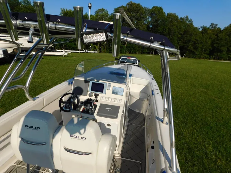 Slide: The Image of 2005 Solid Craft LIMITED 40 boat with dual seats and control panel, set on grassy field. - 6