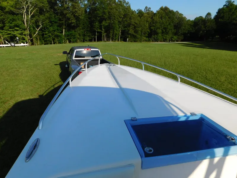 Slide: The Image of Truck towing a 2005 Solid Craft LIMITED 40 boat across a grassy field. - 8