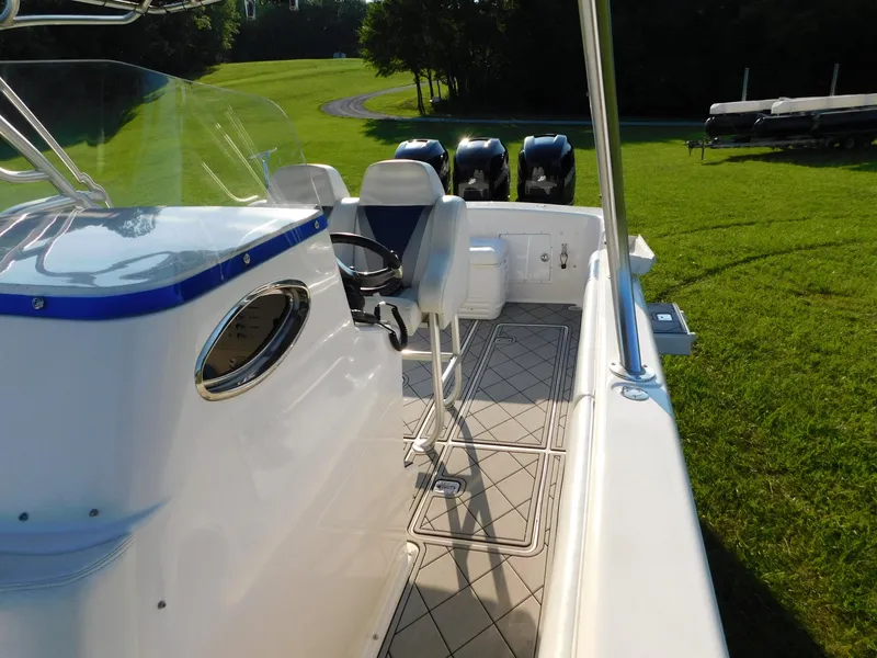 Slide: The Image of Solid Craft LIMITED 40 boat, 2005 model, with triple outboard motors on grassy area. - 9