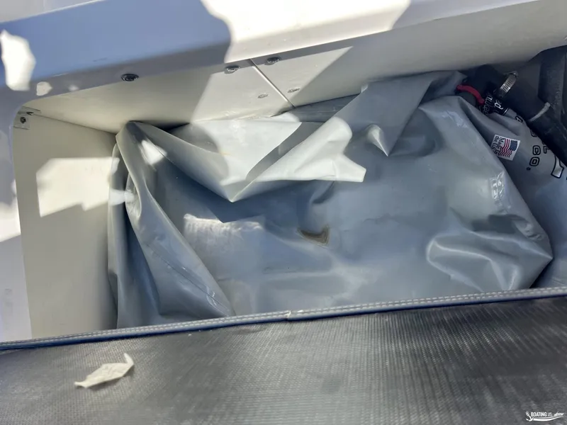 Slide: The Image of Storage compartment of 2019 Chaparral Vortex 223 VRX boat with gray cover. - 10