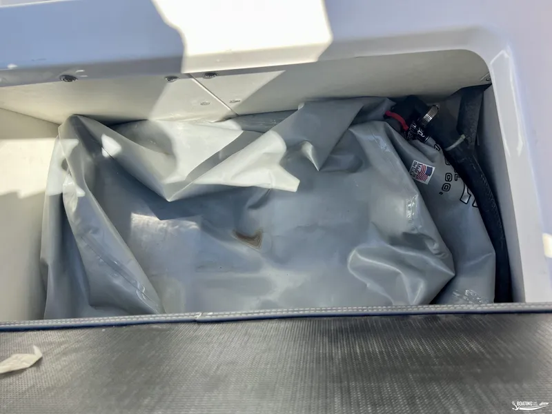 Slide: The Image of Storage compartment of a 2019 Chaparral Vortex 223 VRX boat with a gray cover. - 11