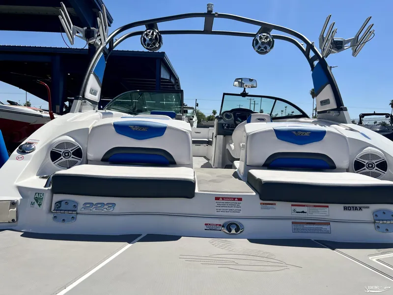 Slide: The Image of 2019 Chaparral Vortex 223 VRX boat, rear view, showcasing seating and speakers. - 2