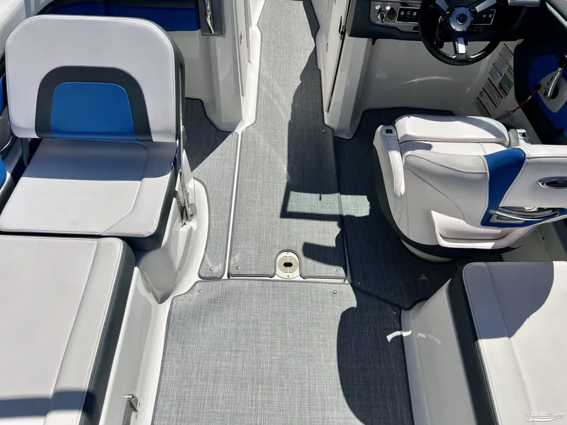 Slide: The Image of 2019 Chaparral Vortex 223 VRX boat interior with gray flooring and blue-accented seating. - 4